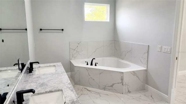 bathroom with vanity and tiled tub