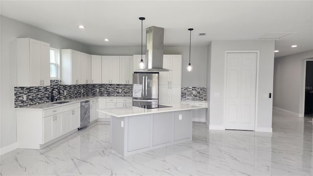 kitchen featuring pendant lighting, white cabinets, a center island, stainless steel refrigerator, and range hood