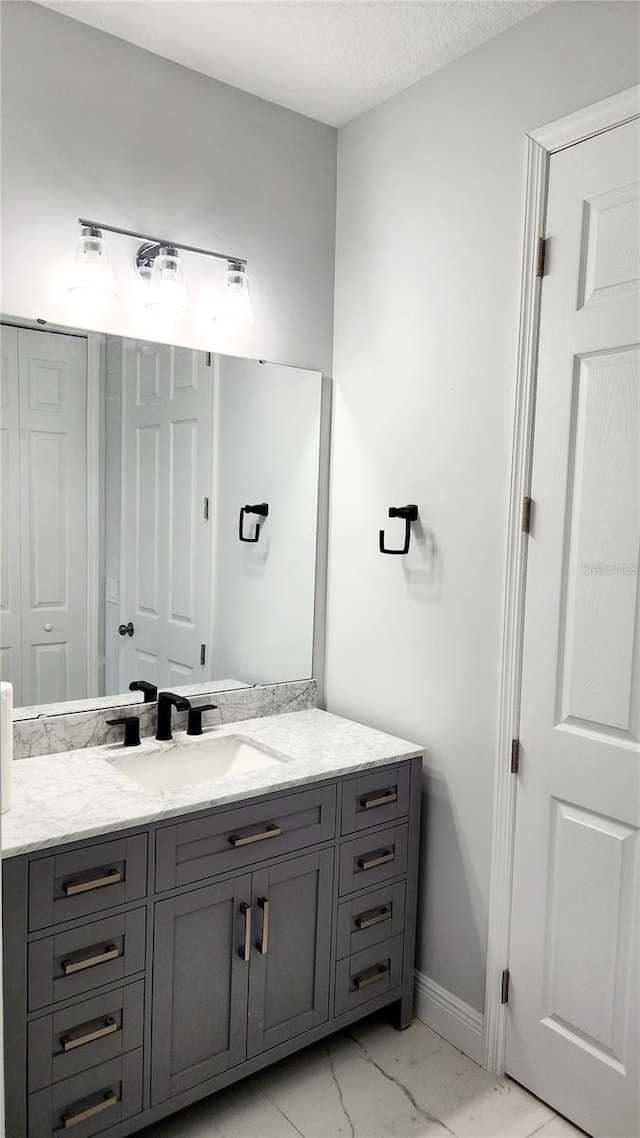 bathroom featuring vanity and a textured ceiling