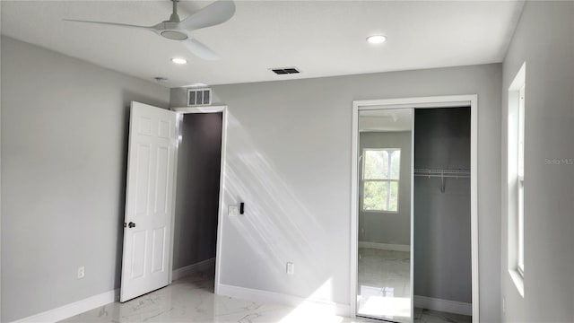 unfurnished bedroom with ceiling fan and a closet