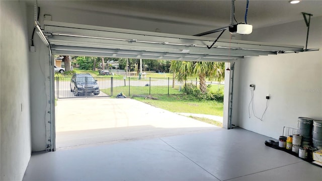 garage featuring a yard and a garage door opener