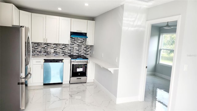 kitchen with decorative backsplash, appliances with stainless steel finishes, and white cabinetry