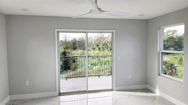 unfurnished room with plenty of natural light and ceiling fan