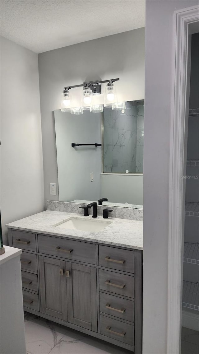 bathroom with vanity and a textured ceiling