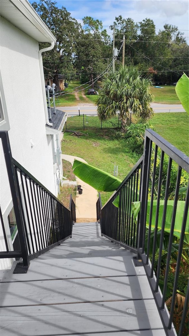 wooden deck featuring a yard