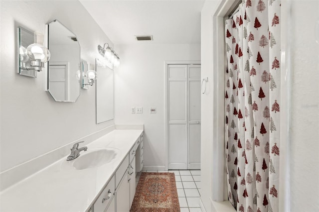 bathroom with vanity, tile patterned flooring, and curtained shower