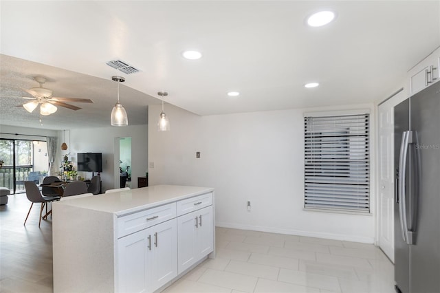 kitchen with ceiling fan, decorative light fixtures, stainless steel fridge with ice dispenser, a center island, and white cabinetry