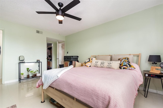 bedroom with a textured ceiling and ceiling fan