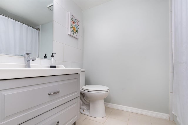 bathroom featuring tile patterned flooring, vanity, and toilet