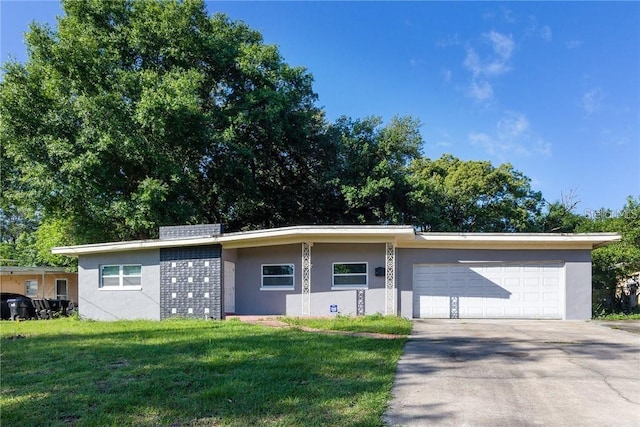 single story home featuring a garage and a front yard