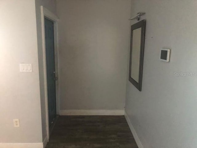 hallway featuring dark hardwood / wood-style flooring