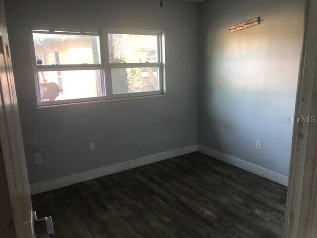 5900 Judy Dee Dr, Orlando, FL 32808 - spare room with dark wood finished floors and baseboards