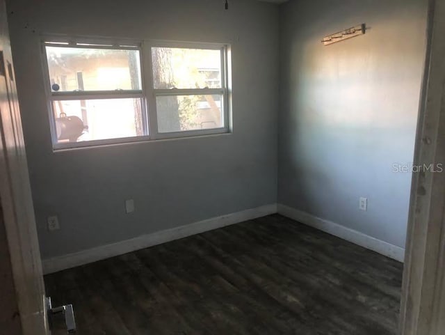 empty room featuring dark hardwood / wood-style flooring