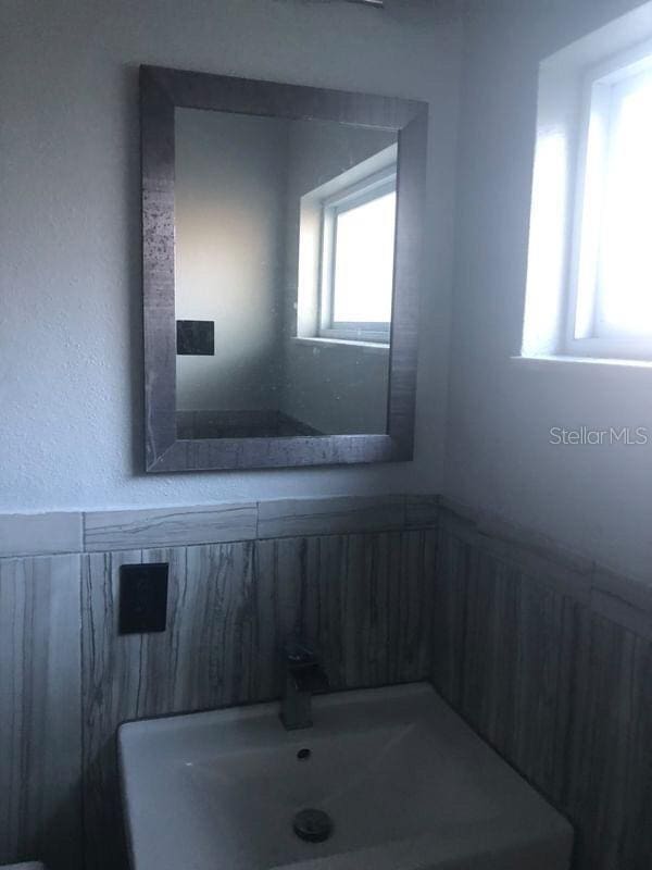 5900 Judy Dee Dr, Orlando, FL 32808 - bathroom featuring wainscoting and a sink