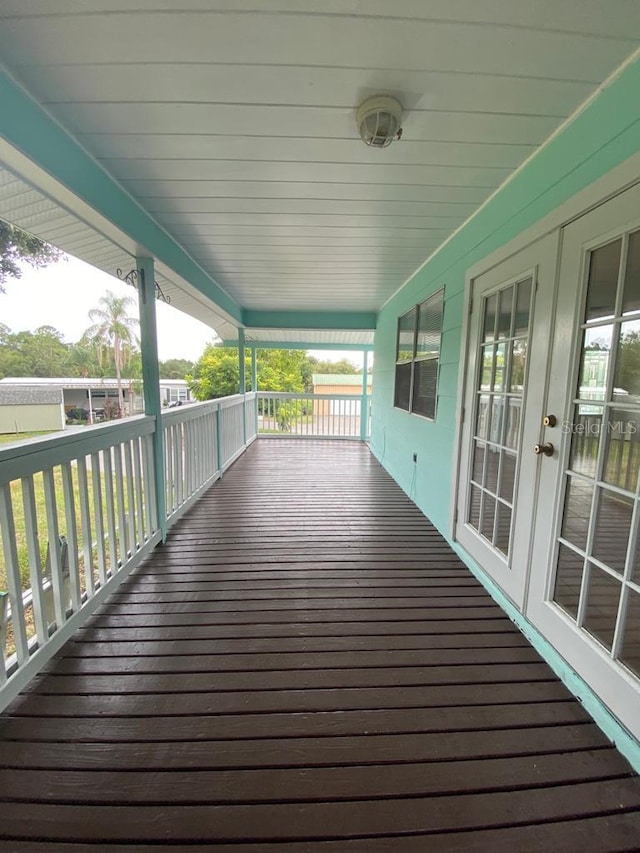 wooden terrace with french doors and a porch