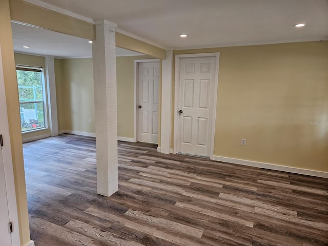 basement featuring ornamental molding and dark wood-type flooring