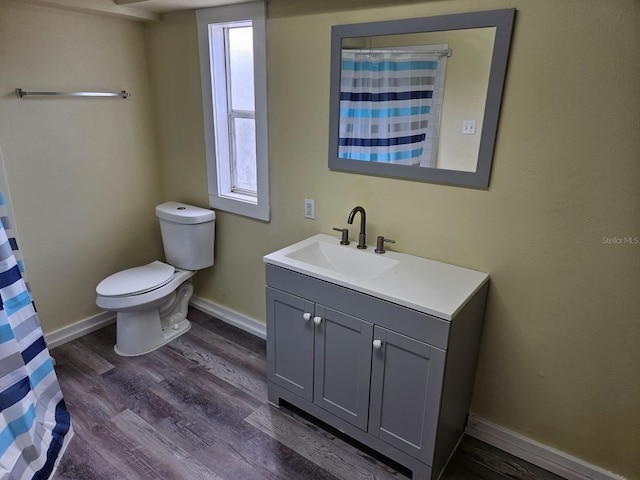 bathroom featuring hardwood / wood-style floors, vanity, and toilet