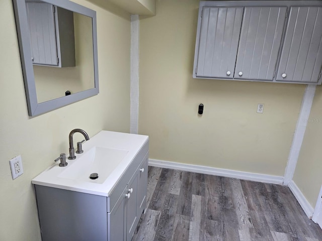 clothes washing area featuring sink and dark wood-type flooring