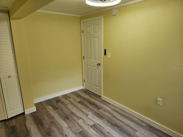 interior space with wood-type flooring and crown molding