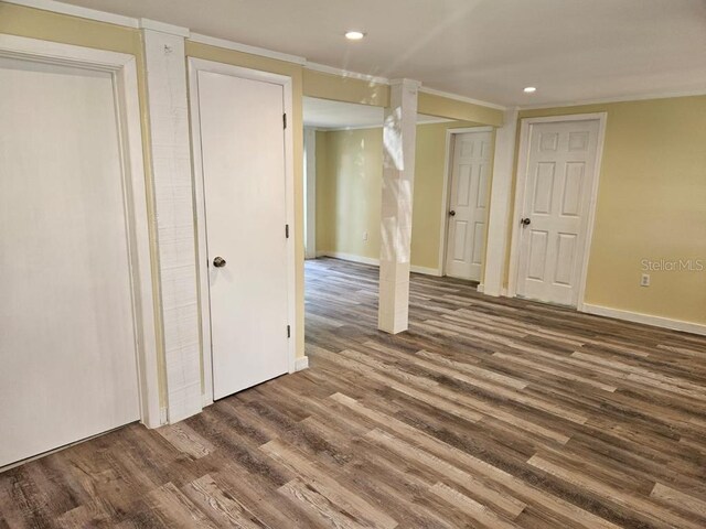 basement featuring dark hardwood / wood-style floors and ornamental molding