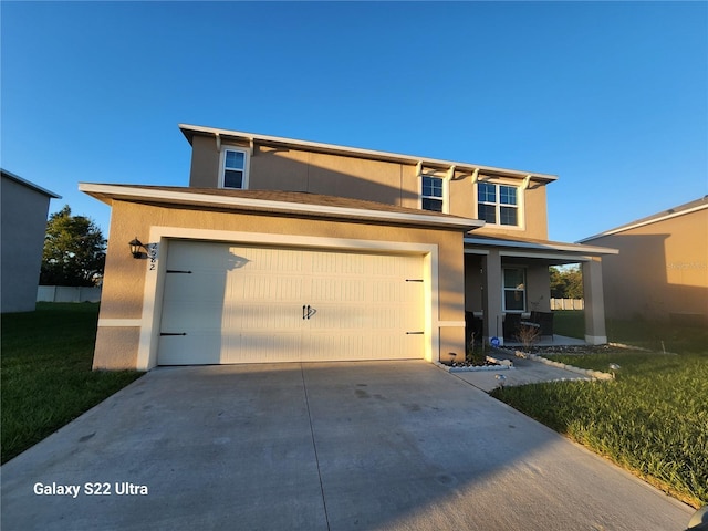 view of front of house with a front yard and a garage