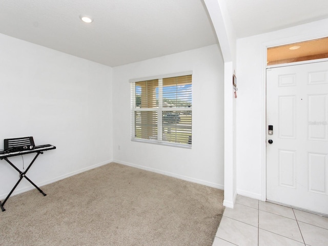 entryway with light colored carpet