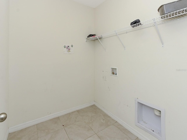 washroom with washer hookup and light tile patterned flooring