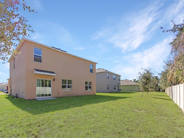 rear view of house with a lawn