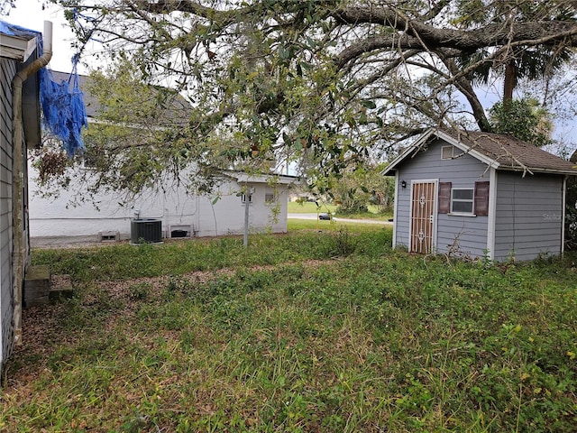 view of yard with an outbuilding and central air condition unit