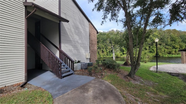 view of side of property featuring a yard and a patio