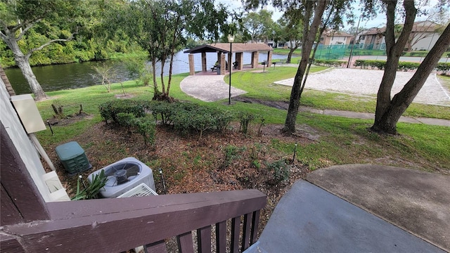 view of yard featuring central AC unit, a water view, and a gazebo