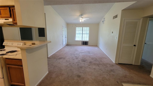 kitchen with white range with electric stovetop, a textured ceiling, vaulted ceiling, light colored carpet, and ceiling fan