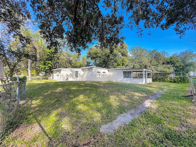 rear view of property with a lawn