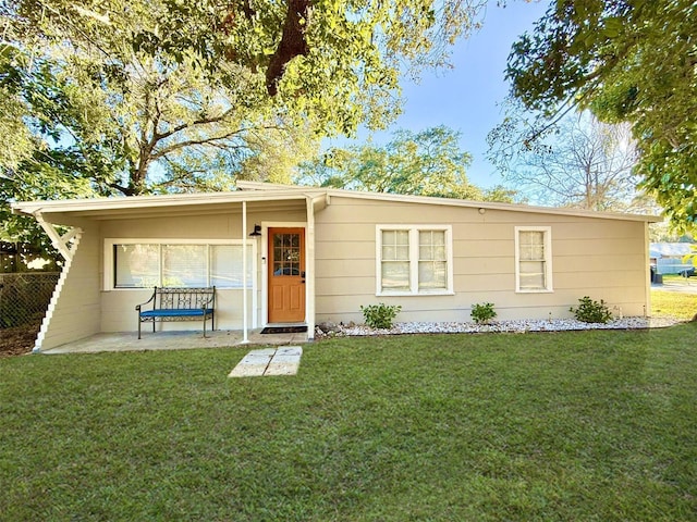 ranch-style home featuring a patio area and a front lawn