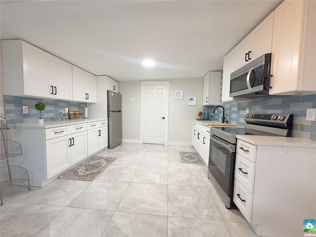 kitchen featuring white cabinetry, appliances with stainless steel finishes, and sink