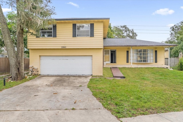 view of front facade with a garage and a front lawn