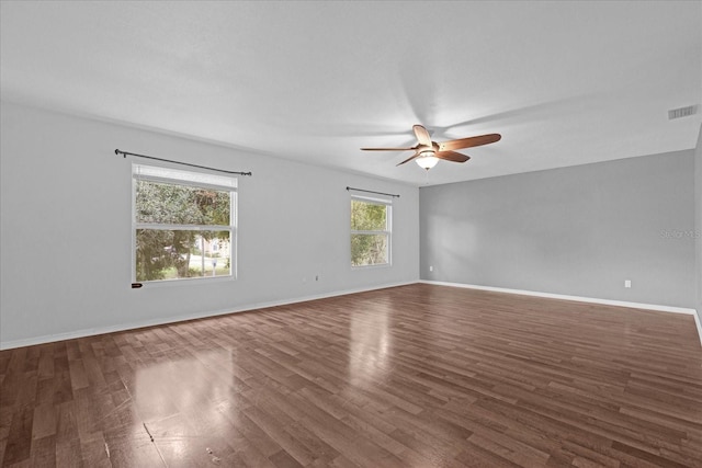 spare room with dark hardwood / wood-style floors and ceiling fan