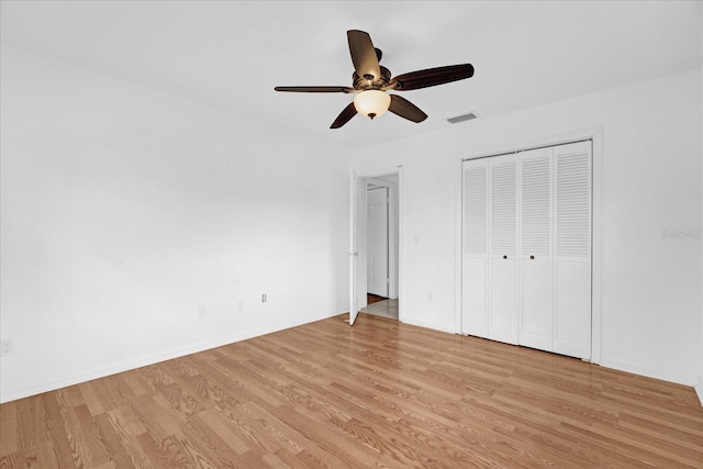 unfurnished bedroom with a closet, ceiling fan, and light hardwood / wood-style flooring