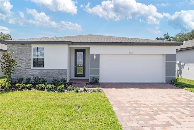 view of front of house with a garage and a front yard