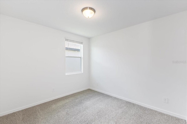 unfurnished room featuring carpet