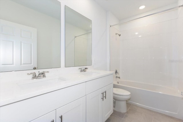 full bathroom featuring toilet, vanity, tile patterned floors, and shower / washtub combination