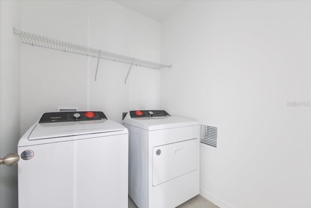 washroom featuring washer and clothes dryer