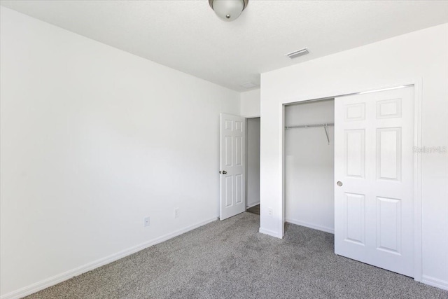 unfurnished bedroom featuring carpet and a closet