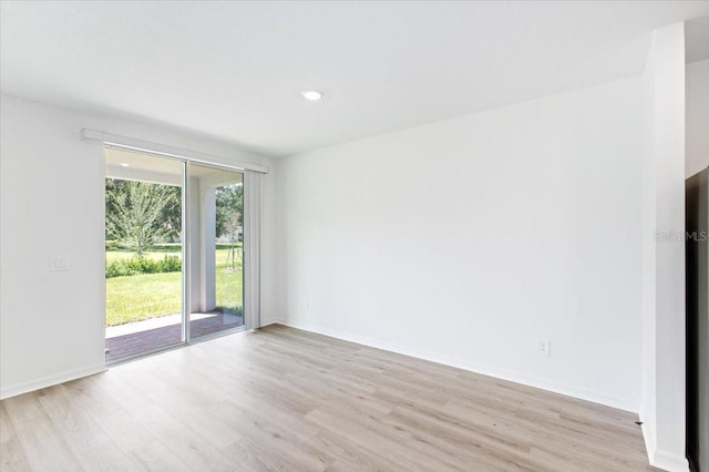 unfurnished room with light hardwood / wood-style flooring