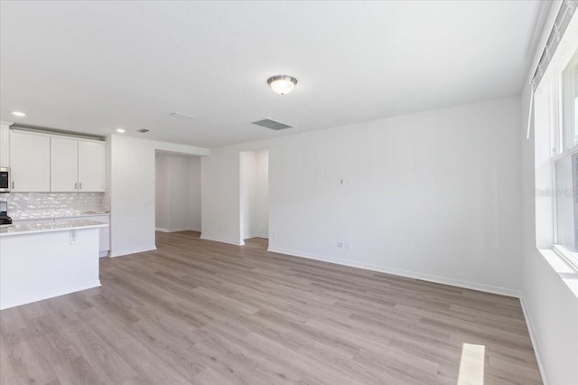 unfurnished living room featuring light hardwood / wood-style floors