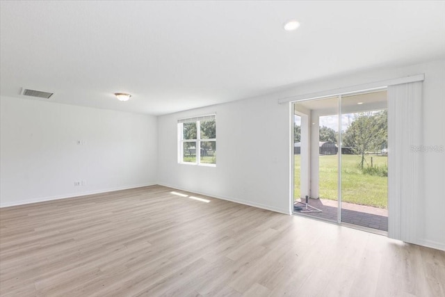 spare room featuring light hardwood / wood-style floors