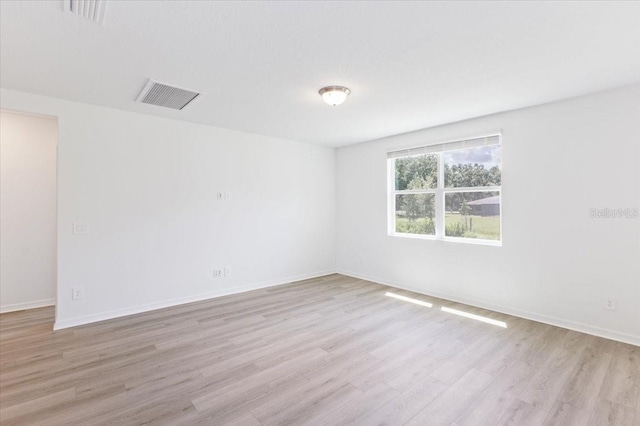 empty room with light hardwood / wood-style flooring