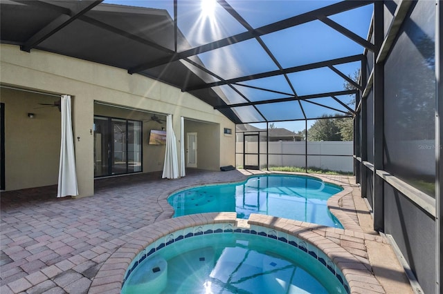 view of pool featuring a lanai, an in ground hot tub, and a patio