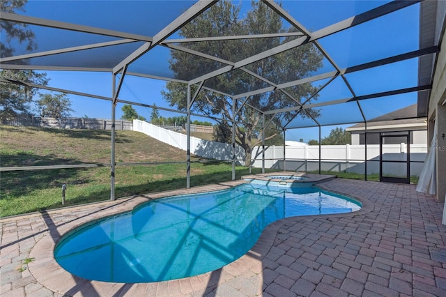 view of swimming pool with a lanai, a patio area, an in ground hot tub, and a lawn