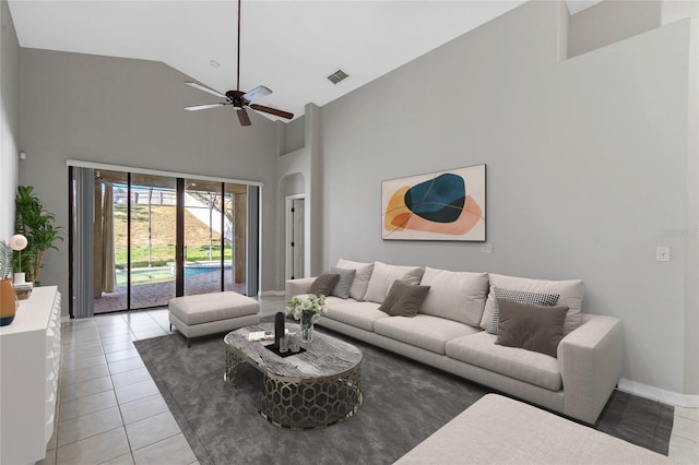 living room featuring light tile patterned floors, high vaulted ceiling, and ceiling fan